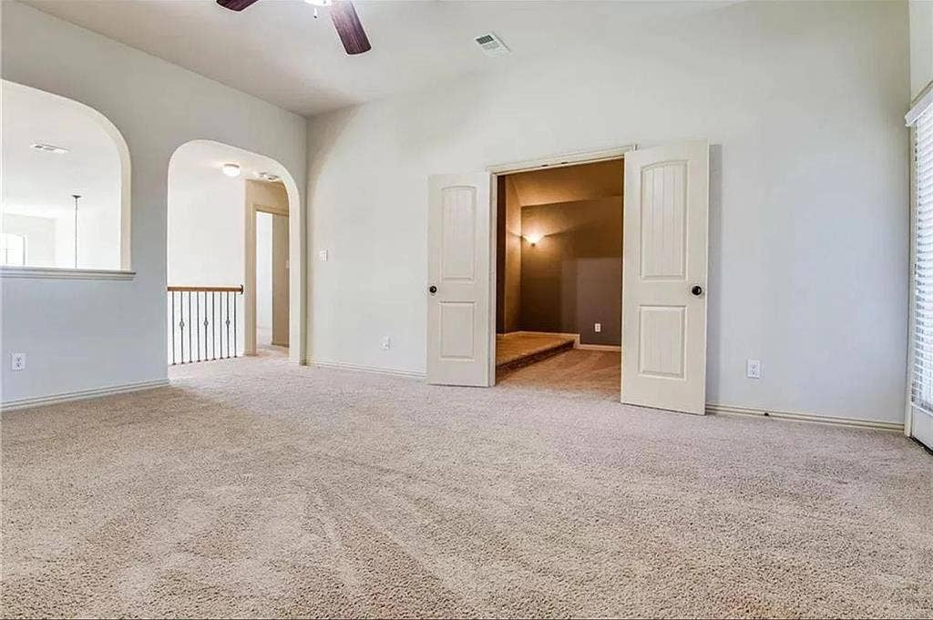 13990 Stevens Point Drive, Frisco, TX 75033 Carpeted interior space featuring light-toned walls, a ceiling fan, and arched openings