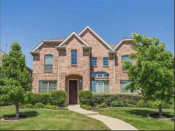 13990 Stevens Point Drive, Frisco, TX 75033 Brick exterior featuring gables, arched windows, and a dark paneled front door