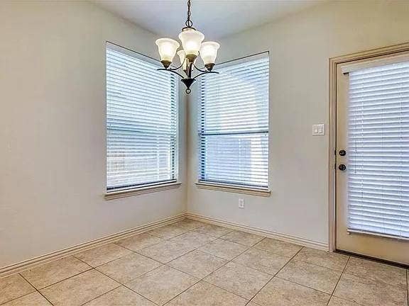 13990 Stevens Point Drive, Frisco, TX 75033 Neutral-toned ceramic tile flooring complemented by a classic chandelier with frosted glass shades