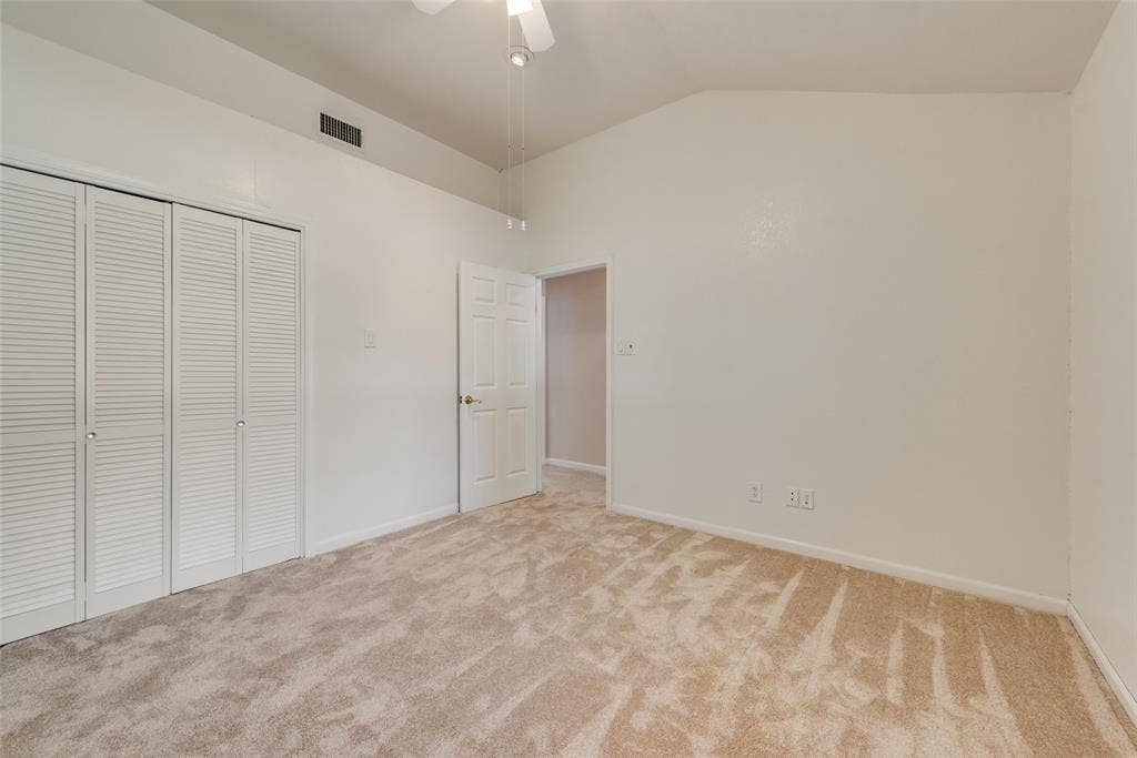 Third bedroom featuring a vaulted ceiling