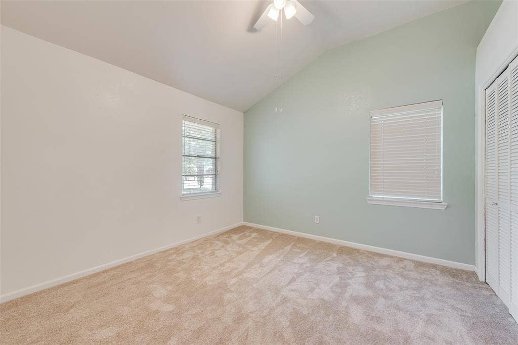 Third bedroom featuring a vaulted ceiling