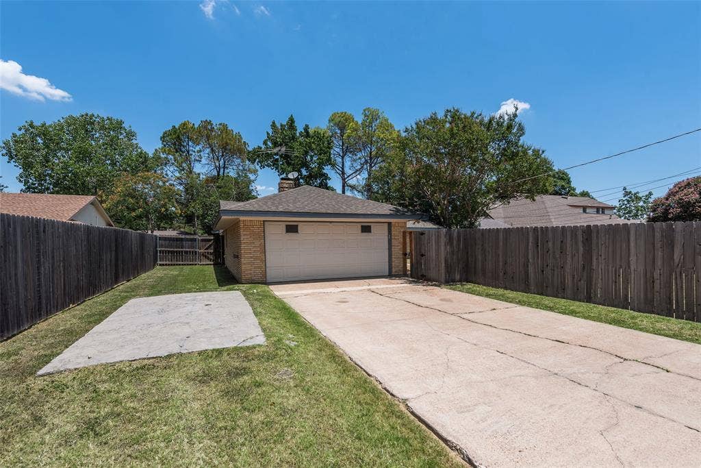Alley access to large driveway, 2 car attached garage, and additional concrete pad for parking