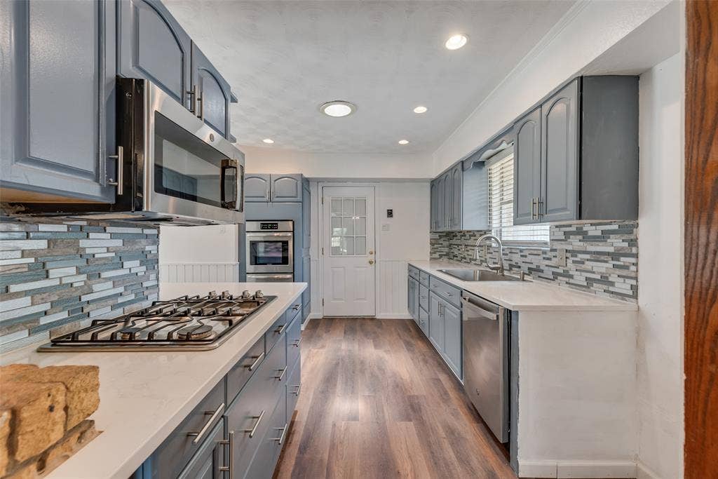 Updated kitchen featuring quartz countertops and stainless steel appliances
