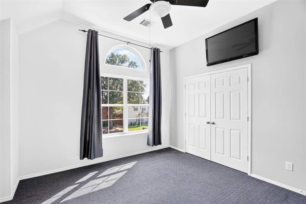 4243 Millview Lane, Dallas, TX 75287 Full size secondary bedroom up with windows looking out on the street, full size closet and ceiling fan light fixture. Jack N Jill bathroom directly across. Floor to ceiling deep linen closet outside bedroom.