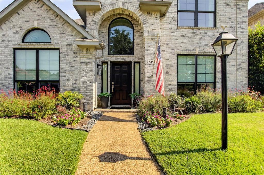4243 Millview Lane, Dallas, TX 75287 Exceptional Curb Appeal Meets Timeless StyleBeautifully maintained and thoughtfully designed, this south-facing two-story home makes a lasting first impression. The striking salt-and-pepper brick exterior is complemented by professionally landscaped grounds, creating elegant curb appeal year-round. A rear-entry garage keeps the front elevation clean and inviting, enhancing the home’s classic architectural charm.