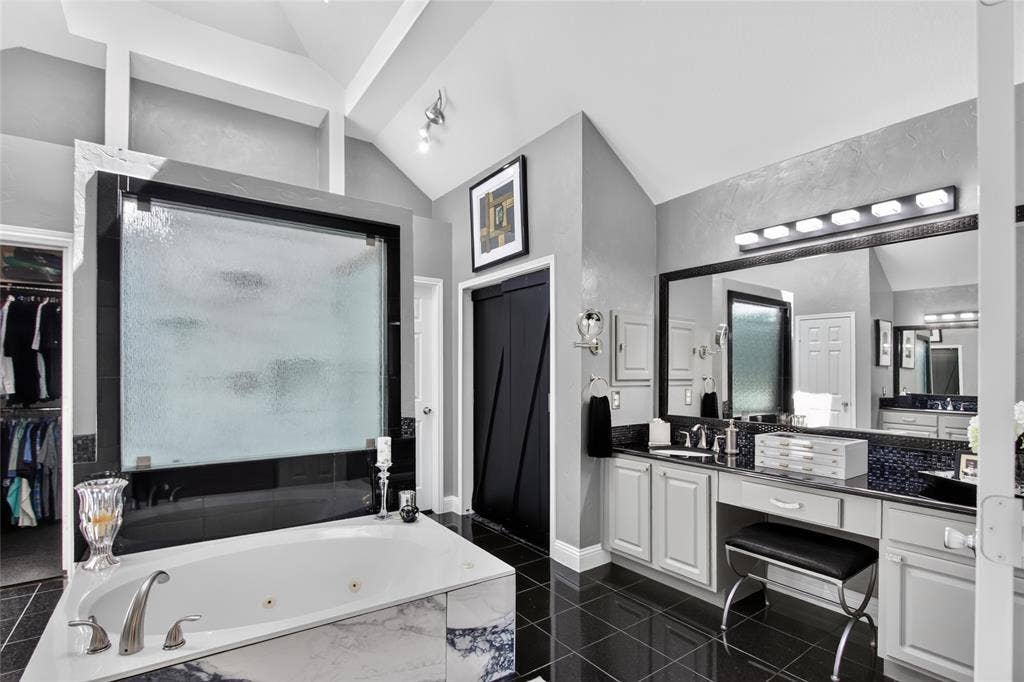 4243 Millview Lane, Dallas, TX 75287 View of one of two separate vanities. Updated lighting, granite counter tops, full horizontal mirror, medicine cabinet and so much counter space and cabinets. Large closet at the back with built-in cubbies and seasonal racks.