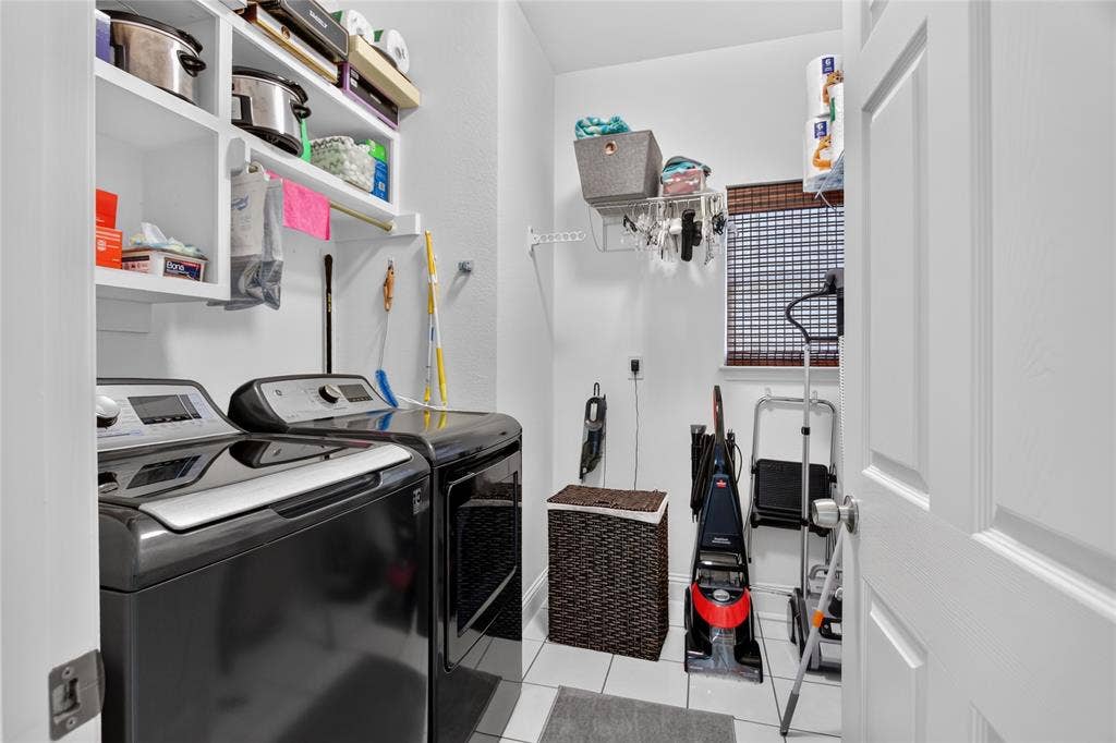 4243 Millview Lane, Dallas, TX 75287 Utility room is oversized with room to add a refrigerator, sink or storage racks. Tile floor and built in open shelves for ease of retreiving items. Room is on the first floor at the back of the home near your Primary retreat.
