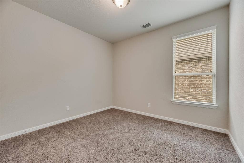 Empty room featuring carpet and healthy amount of natural light