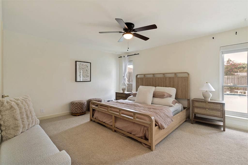 Primary Bedroom with walk in closet, new electronic shades and views of backyard