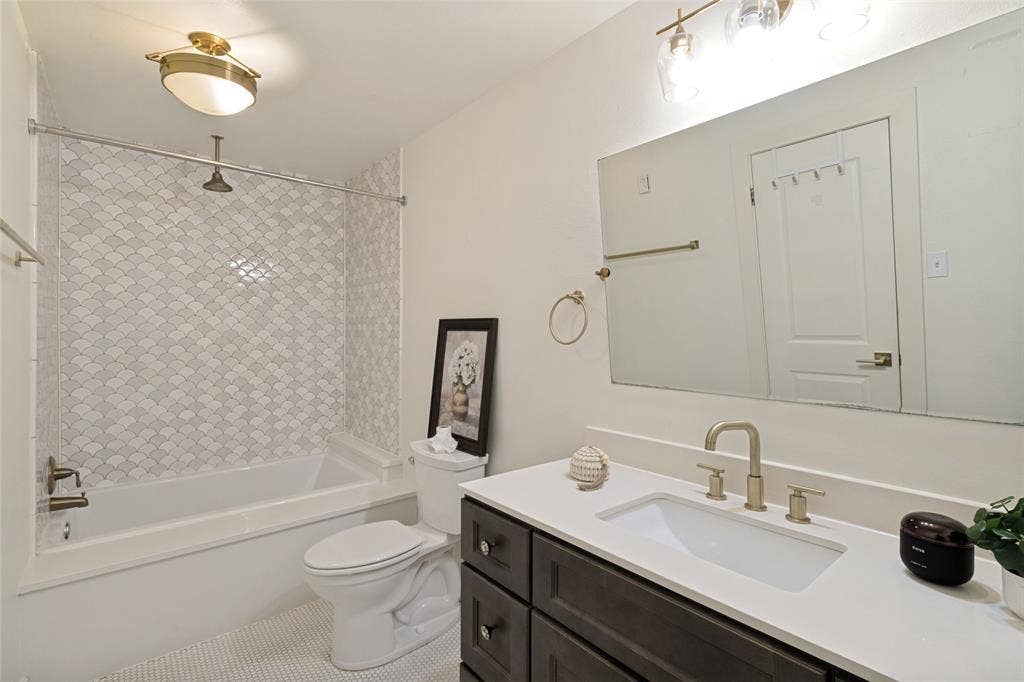 Primary bathroom with updated tile and rain head shower