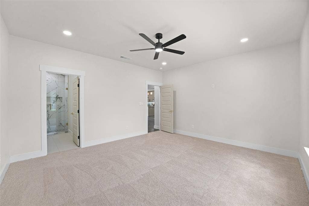 609 Luzon Street, Tool, TX 75143 Spacious interior featuring neutral carpeting, a modern black ceiling fan, and recessed lighting