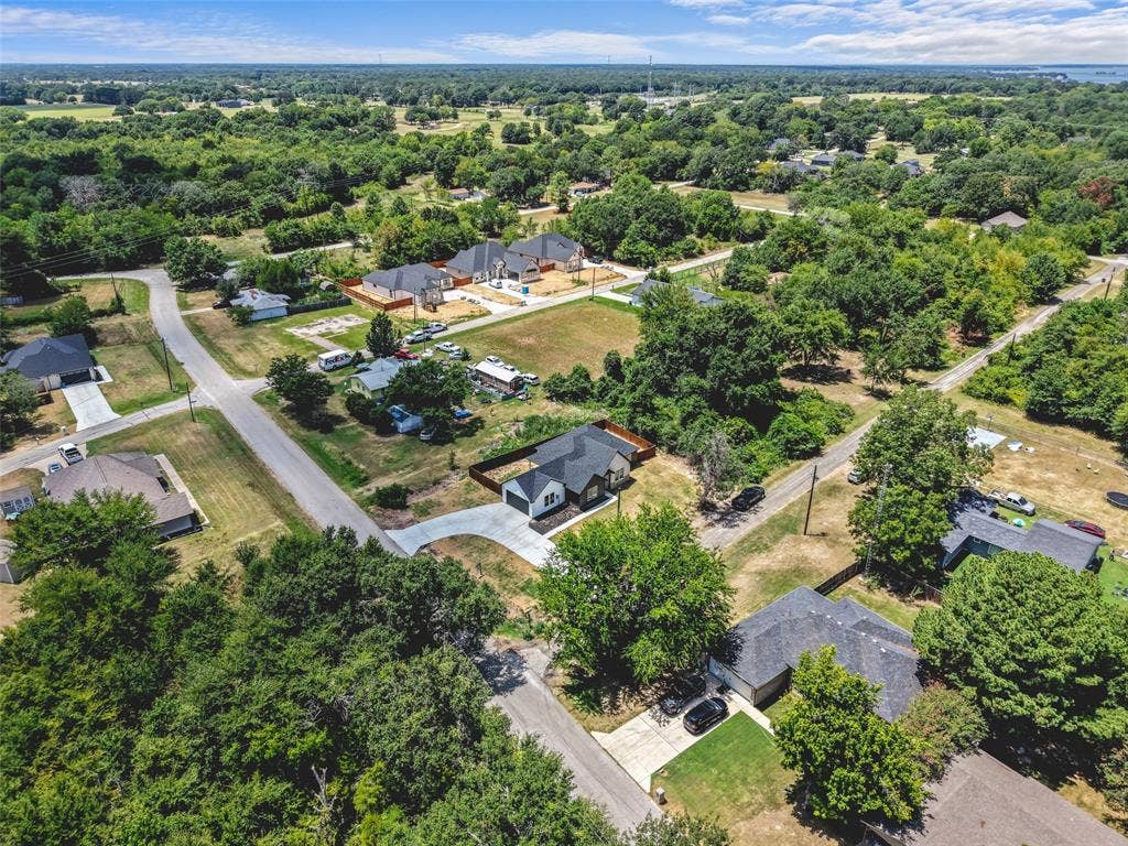 609 Luzon Street, Tool, TX 75143 Aerial perspective showcasing a residential area with varied housing styles and abundant mature trees