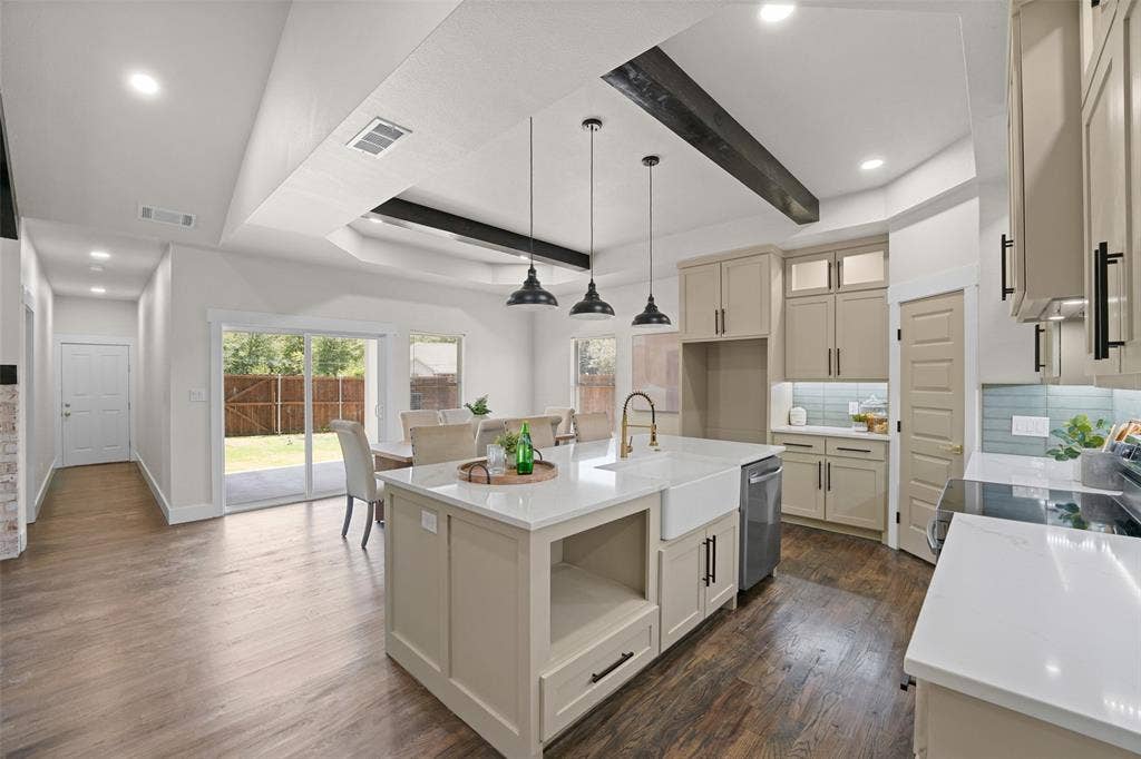 609 Luzon Street, Tool, TX 75143 Kitchen featuring a central island with a farmhouse sink, stone countertops, pendant lighting, and wood-finish flooring