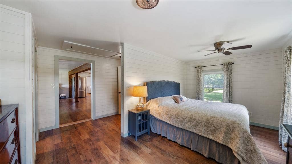 1053 Vz County Road 4206, Athens, TX 75752 Wood-finish flooring throughout, shiplap walls, ceiling fan, and window with outdoor greenery visible