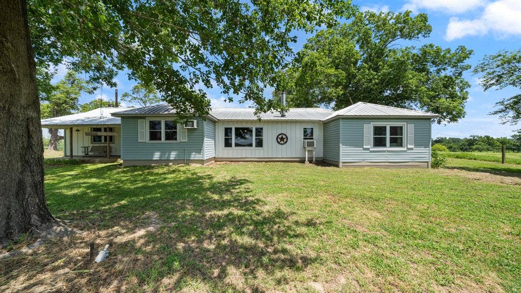 1053 Vz County Road 4206, Athens, TX 75752 Ranch-style exterior with light blue and white siding, featuring a covered porch and multiple windows with white shutters