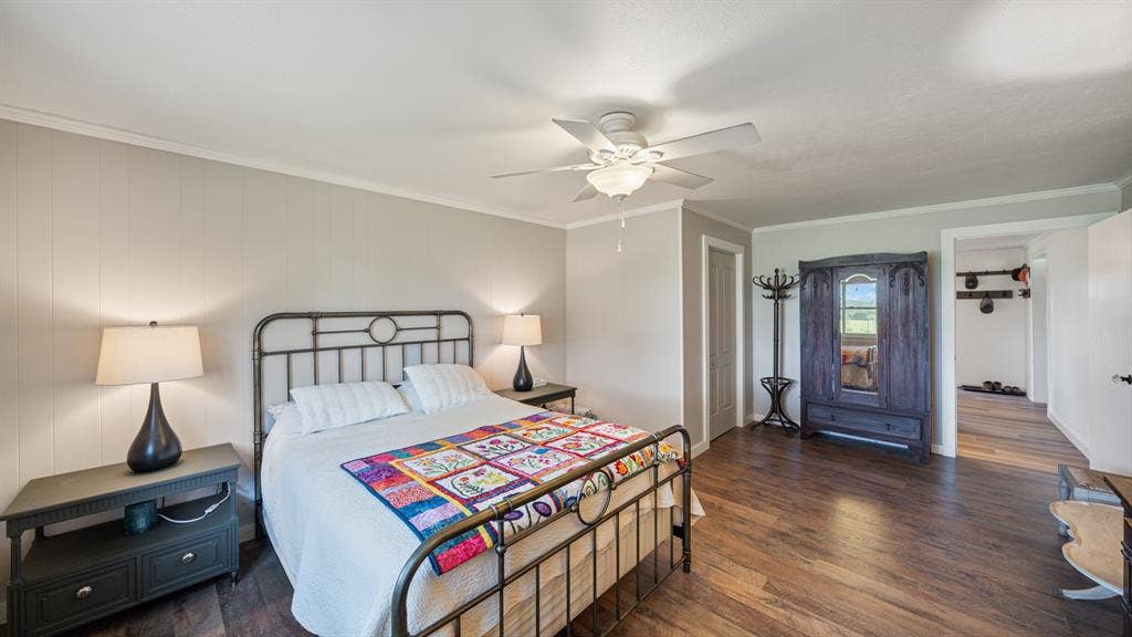 1053 Vz County Road 4206, Athens, TX 75752 Spacious interior with wood-finish flooring, light gray wall paneling, and a white ceiling fan