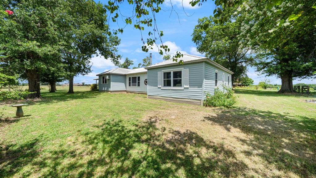 1053 Vz County Road 4206, Athens, TX 75752 Expansive exterior featuring a light blue siding, white window trim, and a metal roof