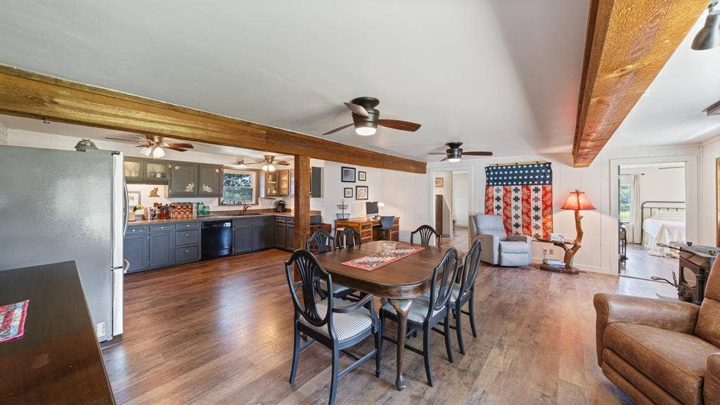 1053 Vz County Road 4206, Athens, TX 75752 Open-concept living area featuring wood-finish flooring, exposed wood beams, and white paneled walls