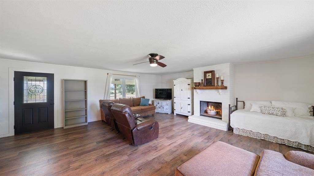 1053 Vz County Road 4206, Athens, TX 75752 Spacious interior room featuring wood-finish flooring, white walls, and a ceiling fan