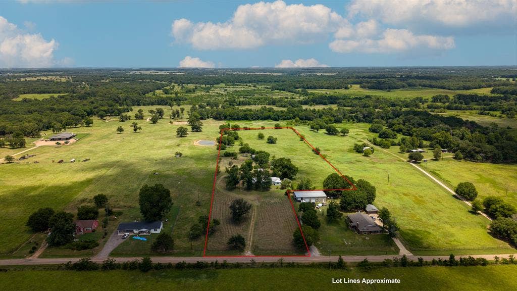 1053 Vz County Road 4206, Athens, TX 75752 Expansive rural landscape featuring a single-story residence, multiple outbuildings, and a pond