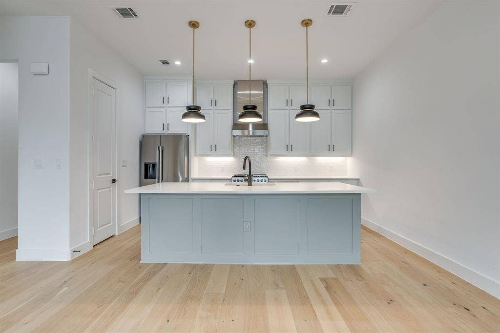 123 Thornton Street, Arlington, TX 76013 Contemporary kitchen featuring a light blue island with a white countertop