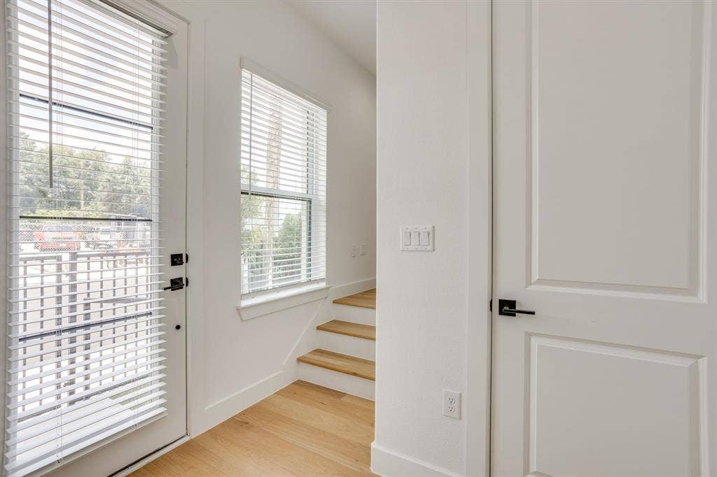 123 Thornton Street, Arlington, TX 76013 Light wood-finish flooring complements the crisp white walls