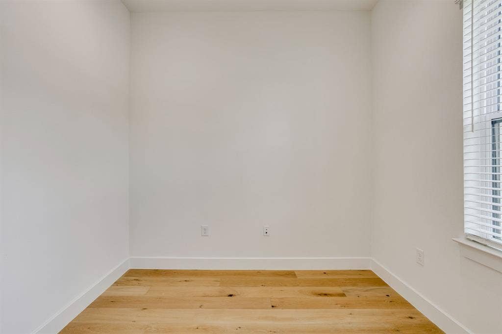123 Thornton Street, Arlington, TX 76013 Bright room with wood-finish flooring, white walls, and white baseboards