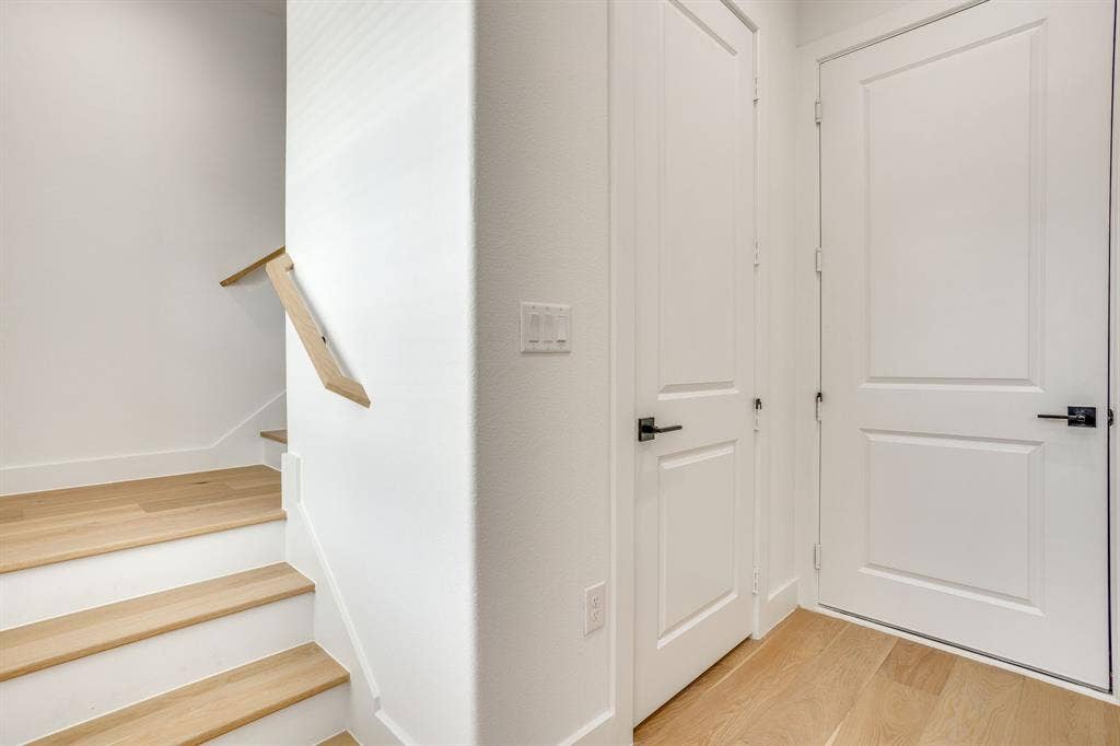 123 Thornton Street, Arlington, TX 76013 Light wood-finish flooring extending into the staircase featuring white risers and a natural wood handrail