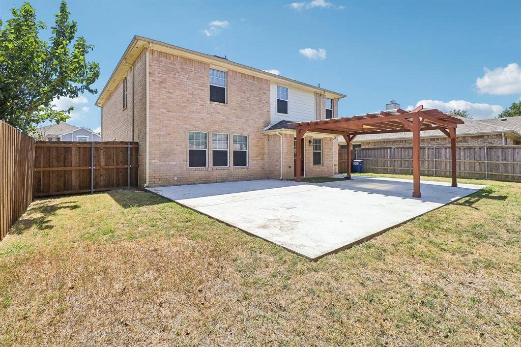 503 Angela Lane, Euless, TX 76039 Expansive concrete patio with an attached wood pergola