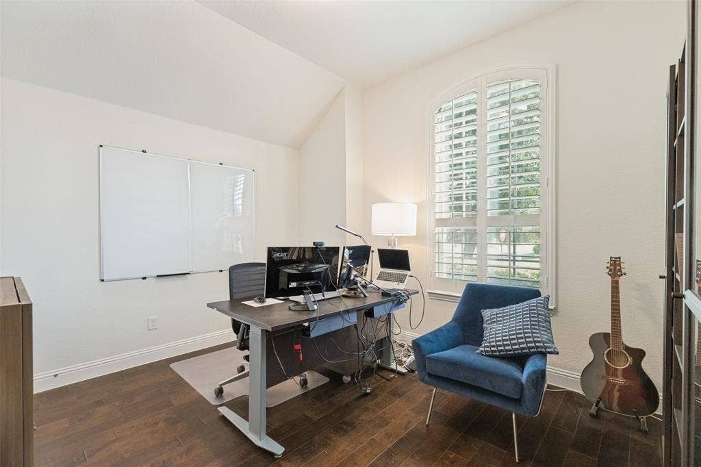 High ceilings and rich wood-finish flooring define this versatile room