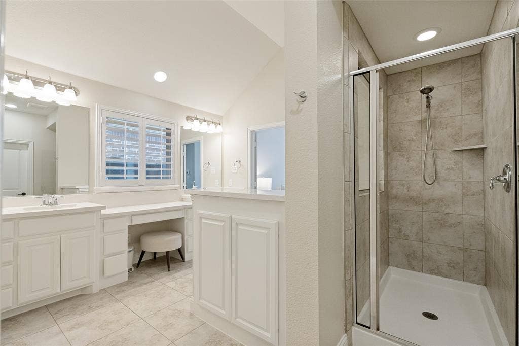 Contemporary bathroom featuring a glass-enclosed shower with tiled walls and a built-in shelf