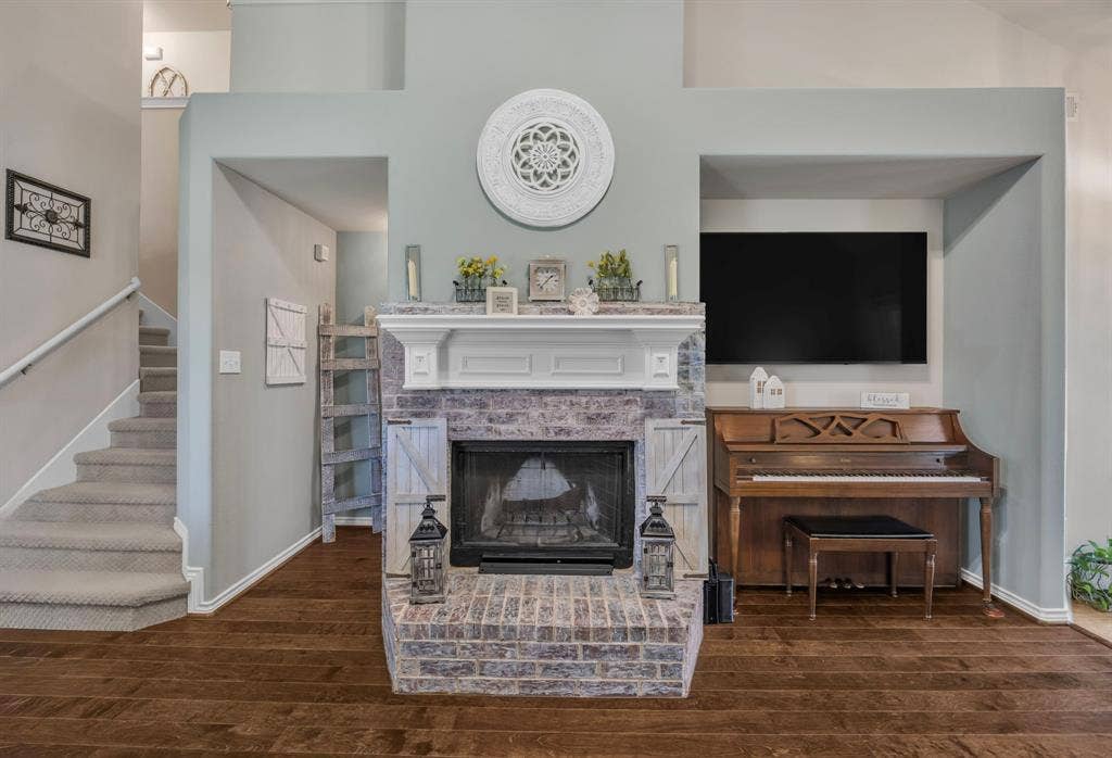 1201 Destiny Court, Wylie, TX 75098 Brick wood burning fireplace with a white mantel.