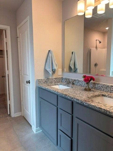 4053 Centerfire Road, Waco, TX 76705 Nice storage under the vanity. Separate shower in the backgound