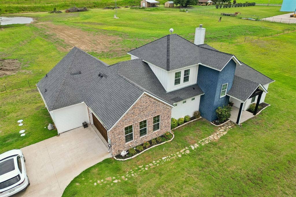 12961 County Road 574, Farmersville, TX 75442 Oversized 2 car garage with stunning wood doors with ample additional parking
