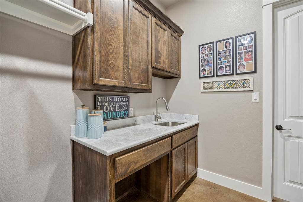 12961 County Road 574, Farmersville, TX 75442 What a laundry room! So much storage, marble countertops, room for hanging clothes extra fridge and even a dog washing station!