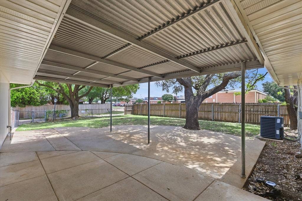 3301 Hillsdale Lane, Garland, TX 75042 Expansive concrete patio with a full-length metal awning