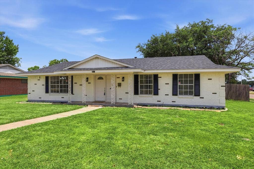 3301 Hillsdale Lane, Garland, TX 75042 Single-story residence featuring white painted brick with black accents