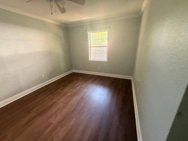 209 Lone Star Road, Trinidad, TX 75163 Room featuring wood-finish flooring, a window with natural light, crown molding, a ceiling fan, and light-colored walls