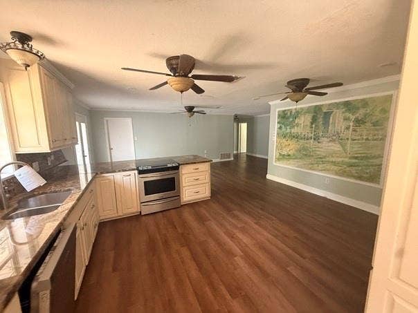 209 Lone Star Road, Trinidad, TX 75163 Open-concept living area featuring wood-finish flooring, a kitchen island with granite-style countertops, stainless steel appliances, white cabinetry, and ceiling fans