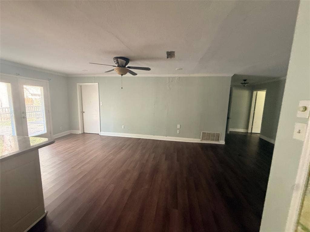 209 Lone Star Road, Trinidad, TX 75163 Spacious room featuring wood-finish flooring, light-toned walls, and a ceiling fan
