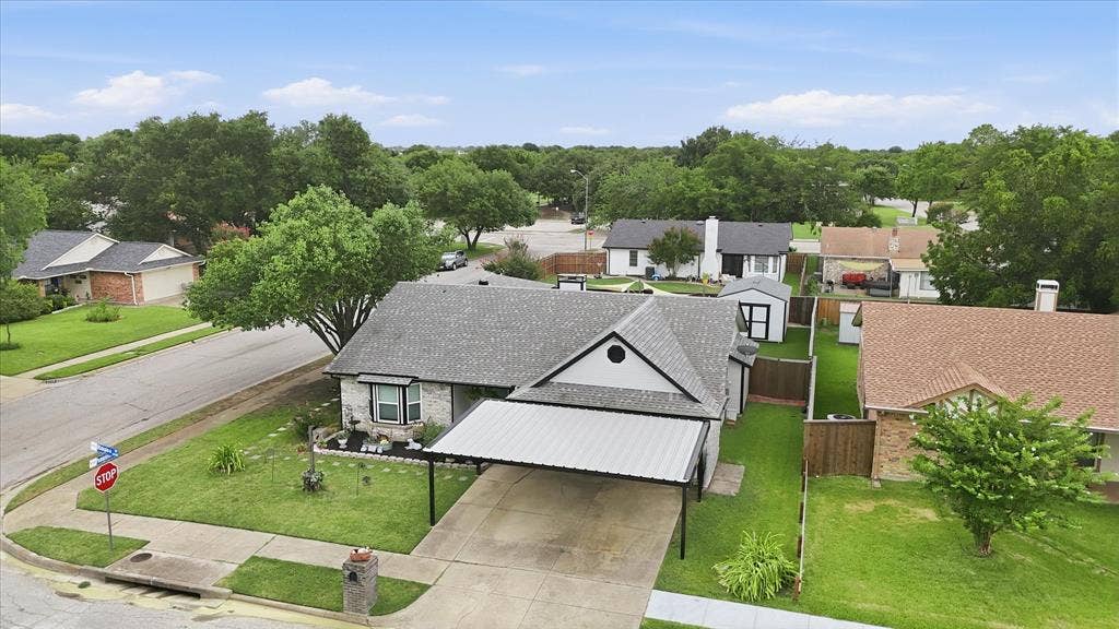 6572 Ridglea Drive, Watauga, TX 76148 Single-story residence featuring a carport, stone and siding exterior, and a gabled roofline