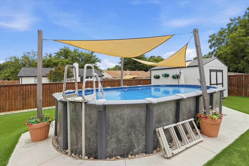 6572 Ridglea Drive, Watauga, TX 76148 Above-ground pool with surrounding concrete patio and faux turf