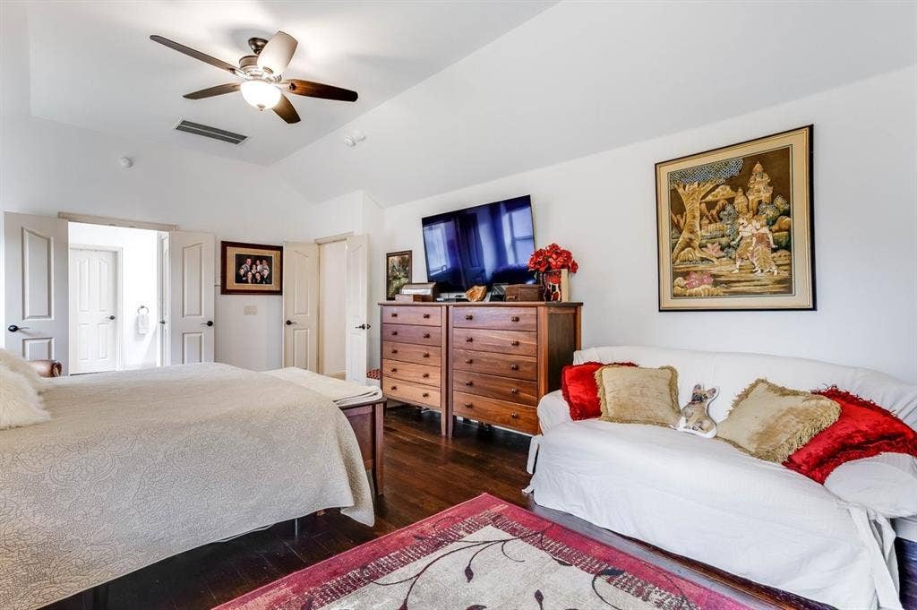 114 Lyndhurst Drive, Wylie, TX 75098 Spacious room featuring vaulted ceilings, dark wood-finish flooring, and white paneled doors