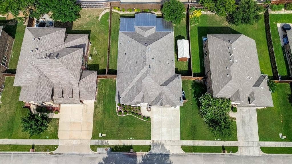 114 Lyndhurst Drive, Wylie, TX 75098 Aerial perspective highlighting three residential properties with gray shingle roofs and concrete driveways