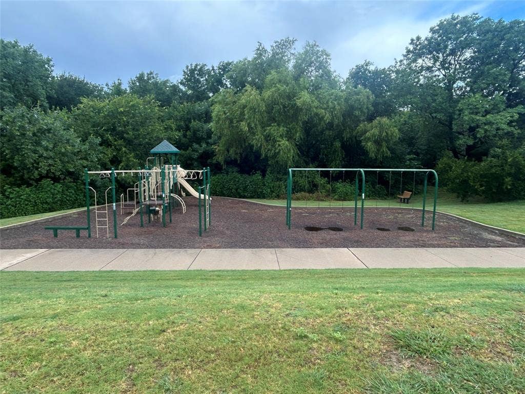 114 Lyndhurst Drive, Wylie, TX 75098 Community playground with a multi-level play structure, swing sets, and a soft ground covering