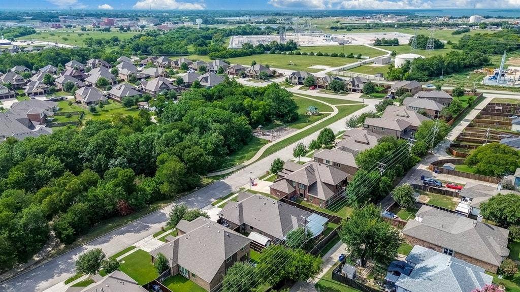 114 Lyndhurst Drive, Wylie, TX 75098 Aerial perspective of a residential neighborhood featuring established homes with gabled roofs, mature trees, and paved streets