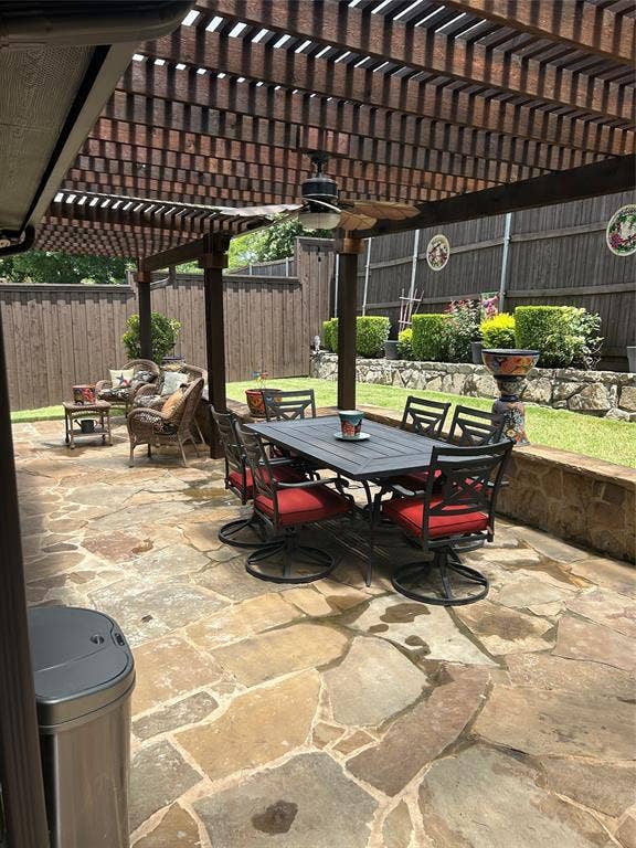 114 Lyndhurst Drive, Wylie, TX 75098 Expansive flagstone patio featuring a large wooden pergola with an integrated ceiling fan