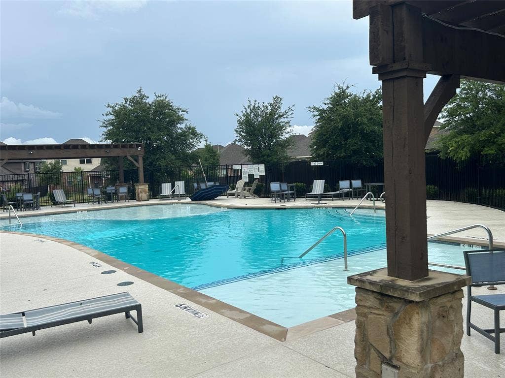 114 Lyndhurst Drive, Wylie, TX 75098 Community swimming pool featuring a curved design with integrated steps and perimeter handrails