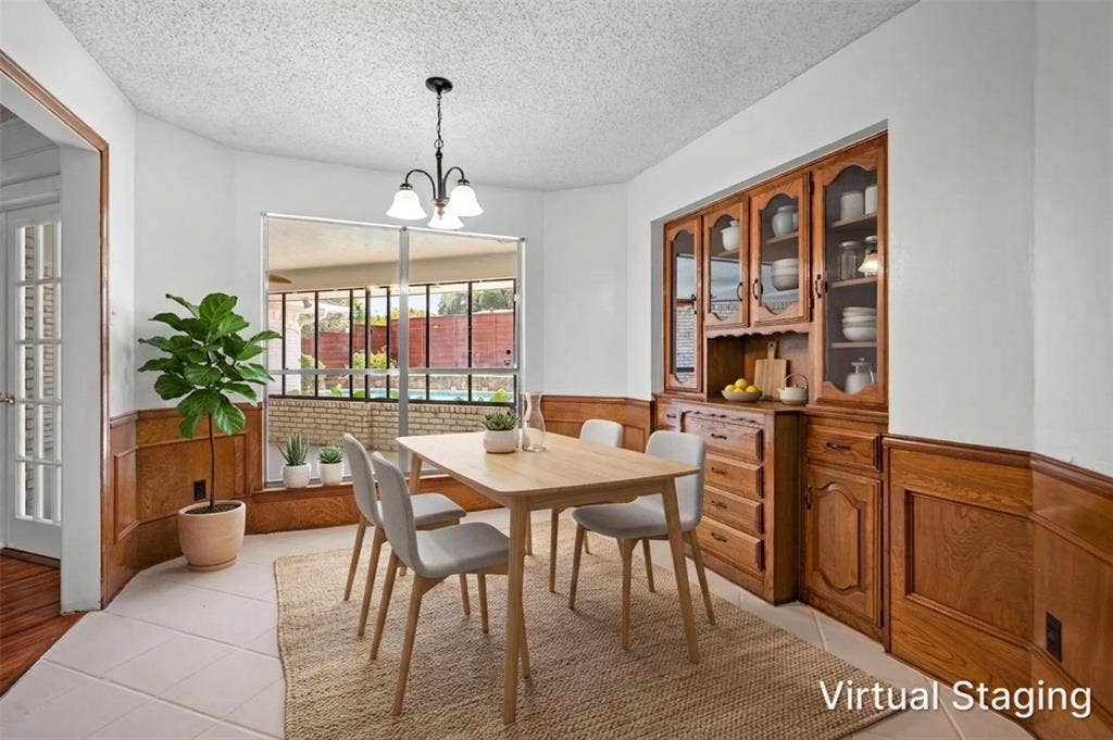 1315 Winding Brook Drive, DeSoto, TX 75115 Built-in wood cabinetry with glass fronts, wood paneling, tiled flooring, and a large bay window