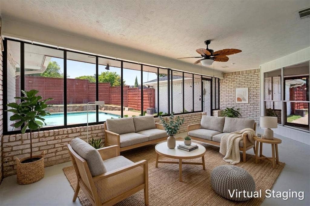 1315 Winding Brook Drive, DeSoto, TX 75115 Enclosed patio featuring floor-to-ceiling windows, exposed brick walls, and a ceiling fan
